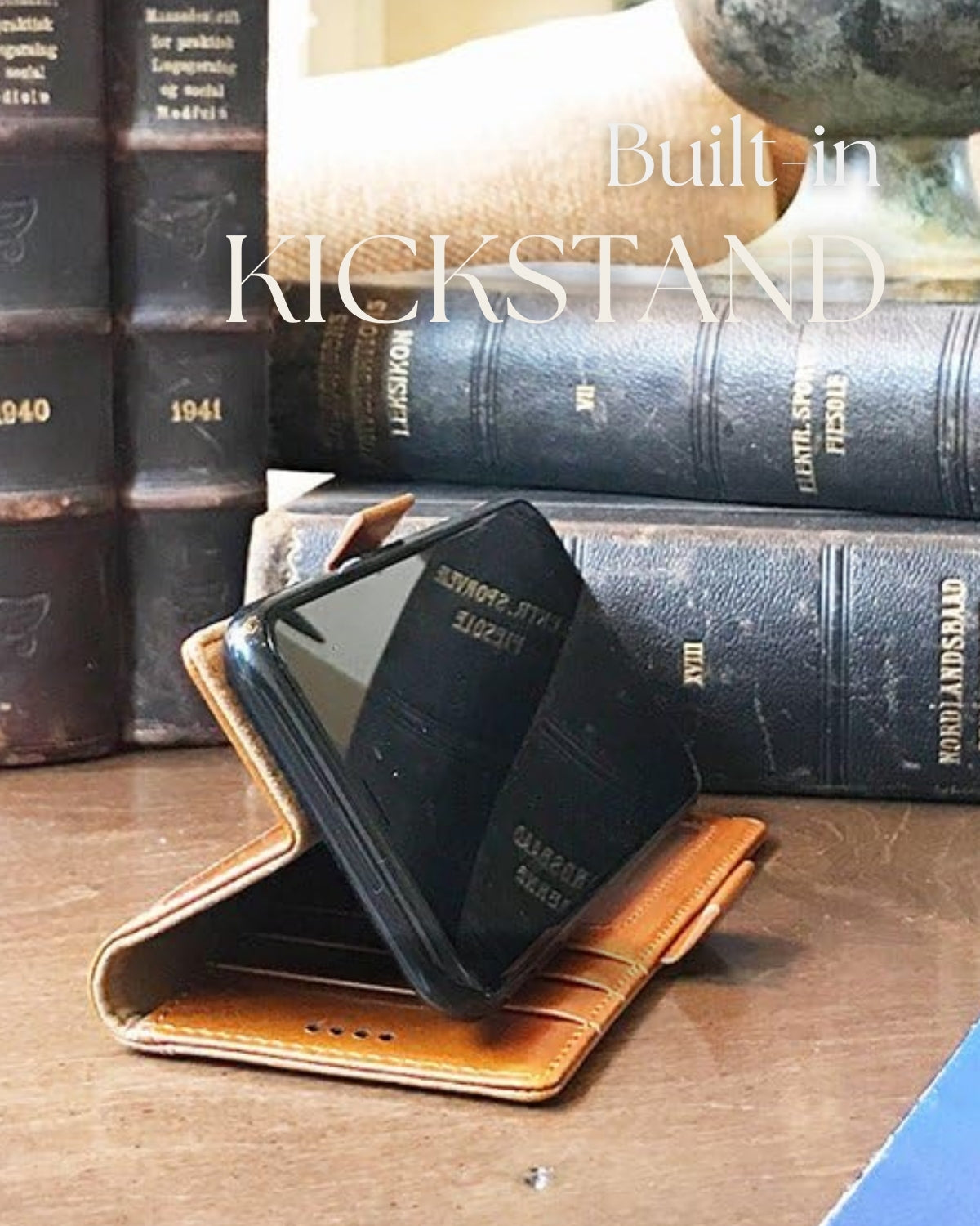 A brown leather wallet case for a Samsung Galaxy S25+Plus, standing upright on a table using its built-in kickstand. The case has multiple card slots visible.